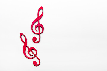 Naklejka premium Red wooden treble clef on white background