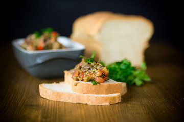 eggplant caviar with tomatoes and a slice of bread