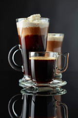 Various coffee drinks on a black background.