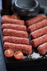Closeup of fresh uncooked balkan cevapi or cevapcici sausages, selective focus