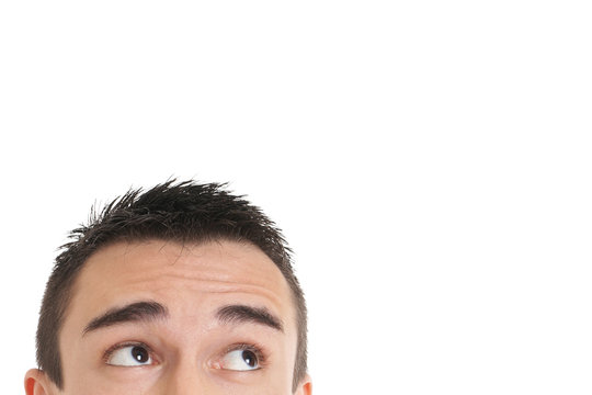 male eyes looking up towards copy space