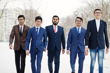 Group of five indian businessman in suits posed and walking outdoor in winter day at Europe.