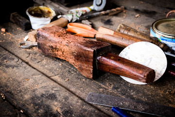 Carpenter wooden hammer on table big brown closeup