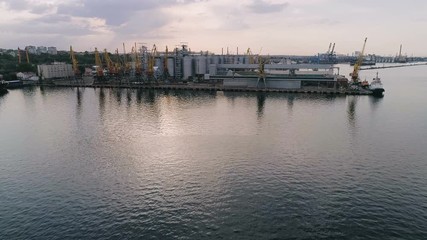 Odessa industrial seaport with cranes and huge metallic cisterns in summer