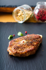 Food concept Marinated Sirloin meat steak on black slate stone plate with copy space