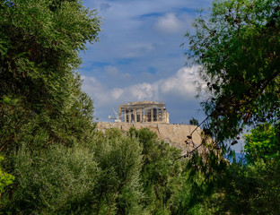 Fototapeta na wymiar parthenon on acropolis hill between green folliage, Athens Greece