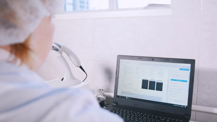 A female looks at the results of tests on the computer