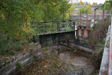Old dam gates with remnants of tree leaves.