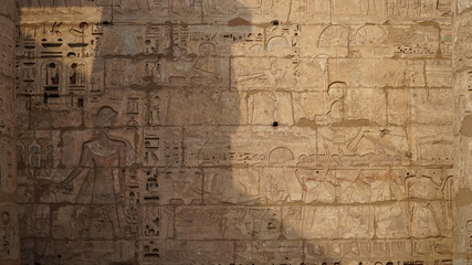 Fototapeta na wymiar Temple of Medinet Habu. Egypt, Luxor. The Mortuary Temple of Ramesses III at Medinet Habu is an important New Kingdom period structure in the West Bank of Luxor in Egypt.