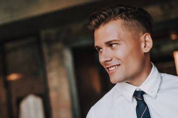 Concept of success and stylish look. Close up portrait of handsome cared smiling business male...