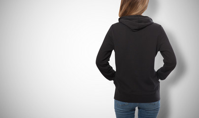 young girl in black sweatshirt, black hoodies view isolated on white background.