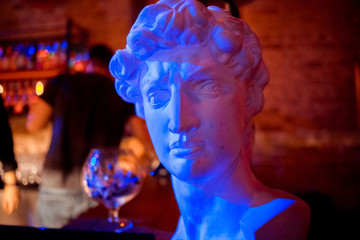 a statue of a man in red and blue light