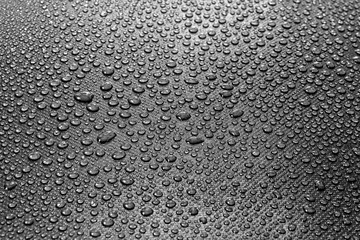 Water drops on dark textured background