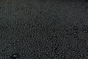 Water drops on dark textured background