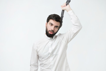 Suicidal spanish businessman strangling himself tie. Have a lot of troubles at work.
