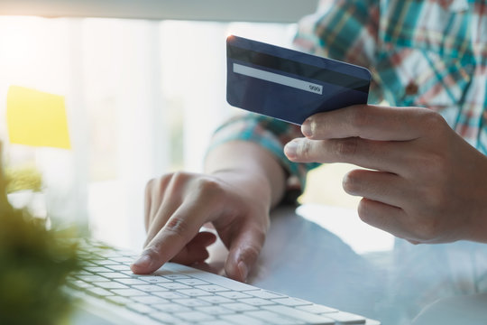 Online Payment,Woman's Hands Holding A Credit Card And Using Laptop Computer For Online Shopping