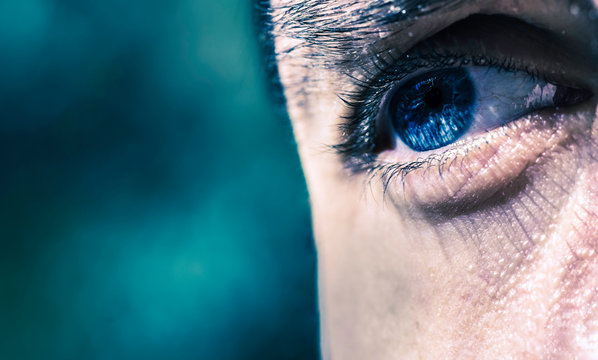 A single blue eye as a cyclope on blue background