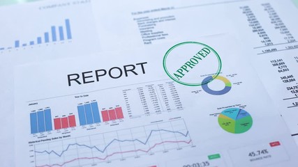 Report approved, worker hand stamping seal on official document, statistics