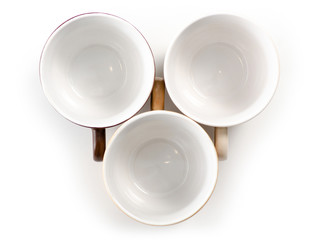 Three cups and saucers empty set on white background isolation, top view