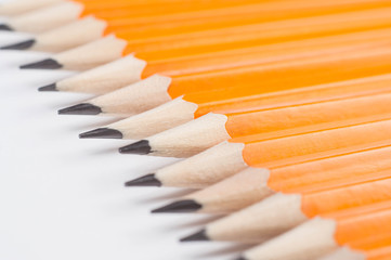 Fototapeta premium orange pencils with graphite rods on a white background