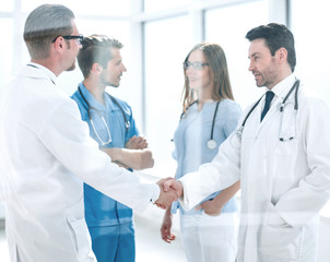 handshake colleagues in the hospital corridor