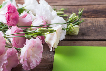 Greeting card with flowers Lisianthus, eustoma in rustic style. Mothers day.