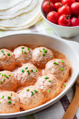 Chacken meatballs baked in creamy tomato sauce