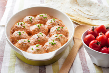 Chacken meatballs baked in creamy tomato sauce