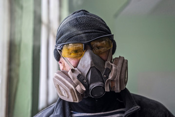 Portrait of a man in a respirator, free space.