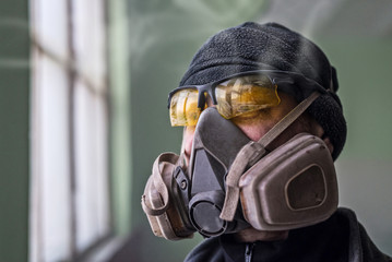 Portrait of a man in a respirator, free space.