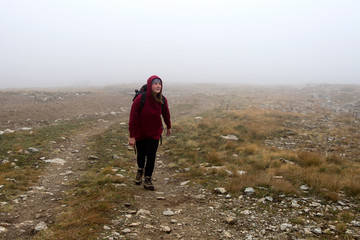 Woman in the fog on the mountain