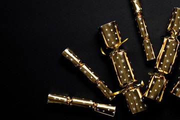 Gold festive Christmas crackers on a dark background