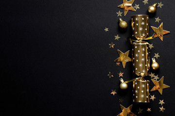 Gold festive Christmas crackers on a dark background