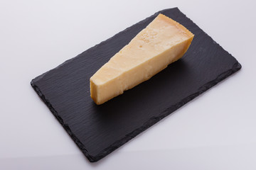 Parmesan slice on a stone slate plate