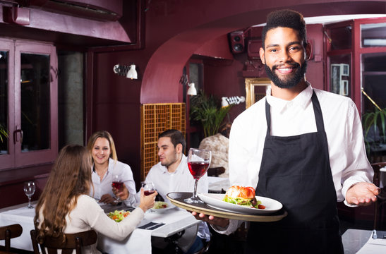 Middle class restaurant and cheerful waiter