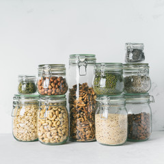 Glass jars with Superfoods nuts and cereals stacked on top of each other