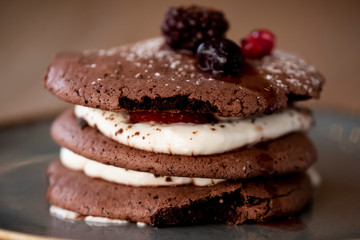 Sandwich chip cookies or whoopie pie or black moon with white cream. Raspberries or blueberries on the pie
