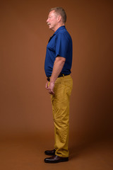 Fototapeta premium Full length profile view portrait of senior man standing