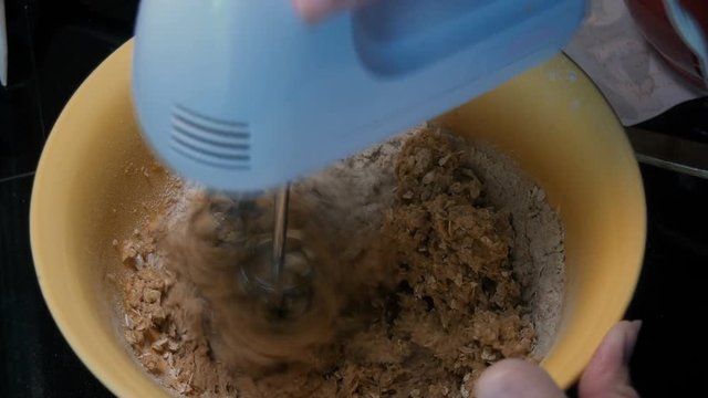 Hand mixer mixing cookie dough with sound