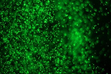 green huge amount flying christmas glitters bokeh texture - fantastic abstract photo background