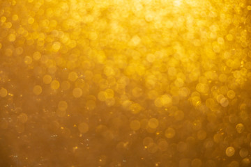 Abstract twinkled bright background with blurred bokeh gold Christmas  lights.background.