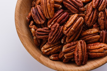 delicious pecan nuts on a white acrylic background