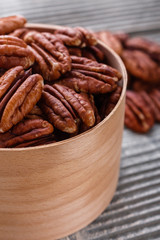 delicious pecan nuts on a rustic wooden background