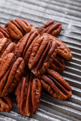 delicious pecan nuts on a rustic wooden background