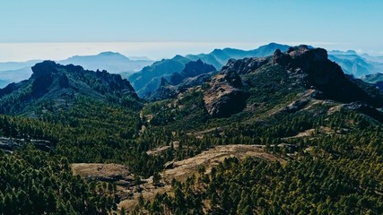 aerial drone image of beautiful stunning landscape view off the Roque Nublo track at Gran Canaria Spain with a valleys and many small peaks on a sunny day