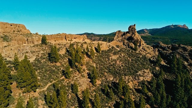 aerial drone image of beautiful stunning landscape view off the Roque Nublo rock formation and plateau at Gran Canaria Spain with a valleys and many small peaks on a sunny day