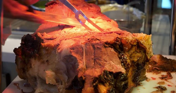 Chef slices grilled roast beef and carving prime rib at the gourmet food restaurant, 4K