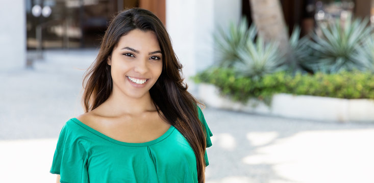 Laughing Latin American Woman In Green Shirt