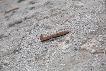 rusted railroad spike on the ground