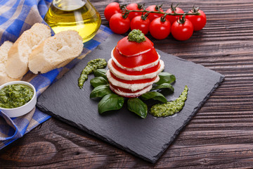 Caprese salad on a wooden rustic background